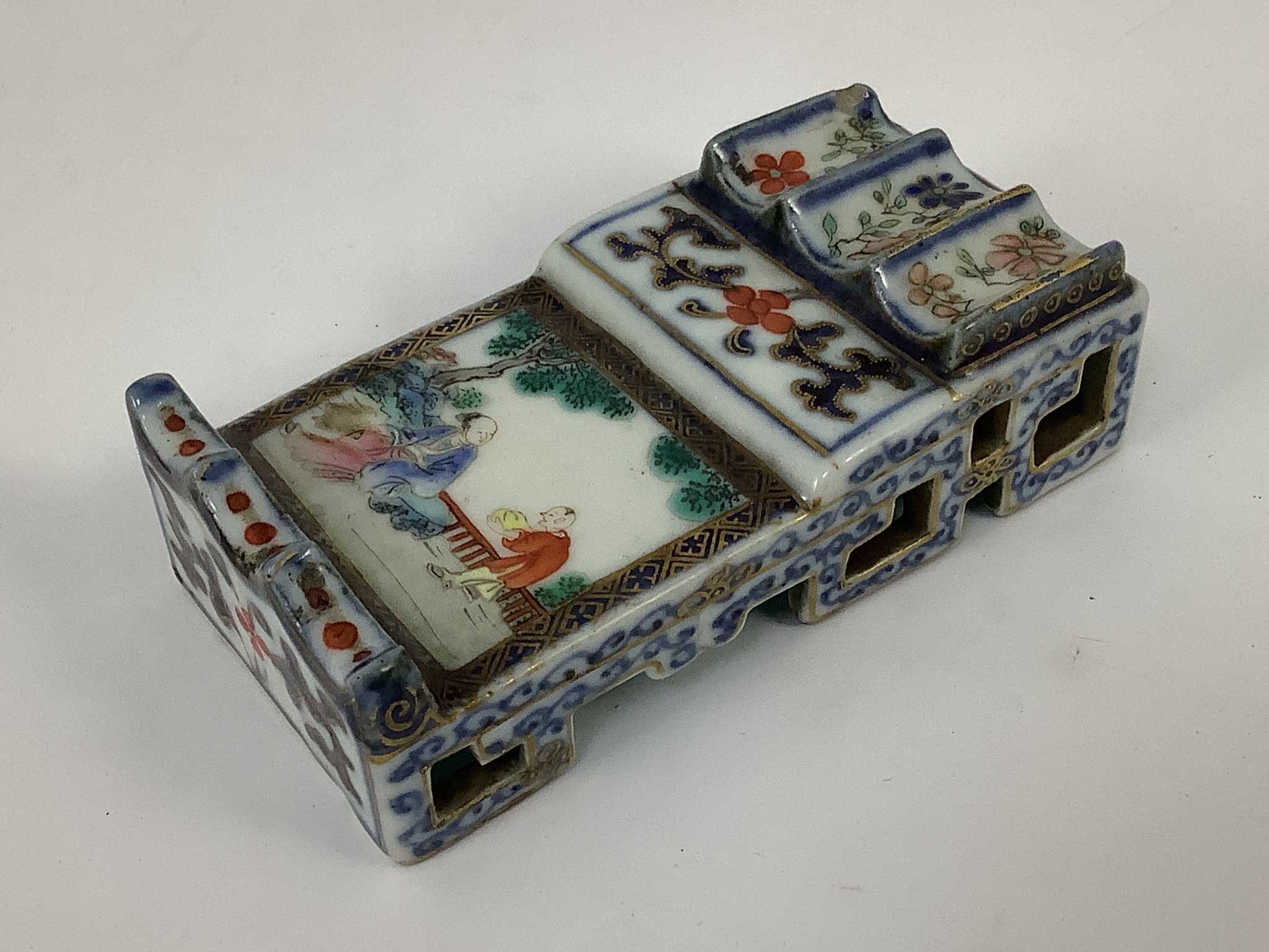 A small Chinese enamelled porcelain brushrest, Jiaqing mark and period (1796-1820), 9cm x 4.5cm, small splinter chip